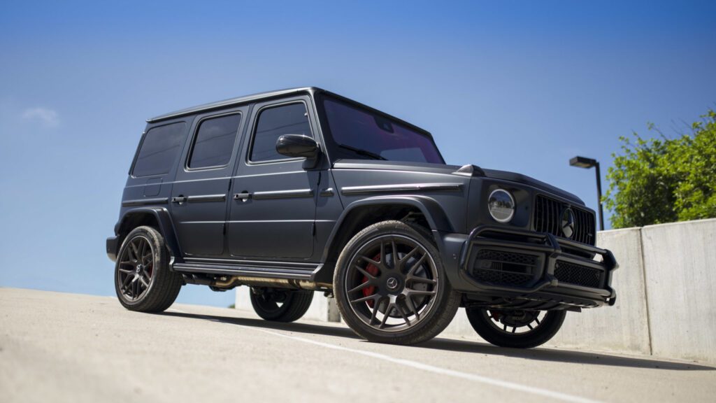 Premium Mercedes-Benz G63 AMG G-Wagon wrapped in gloss British Racing Green vinyl by Wrap Royale in Orlando, FL, featuring luxury vehicle wrap installation, black accents, and professional automotive customization.