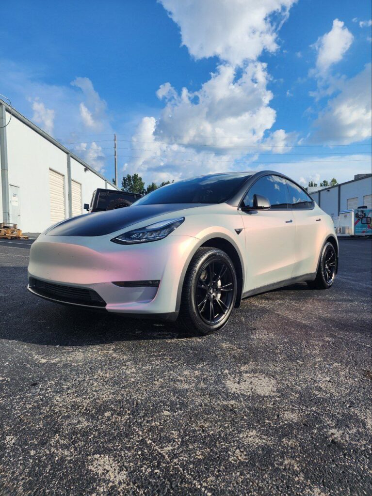 Tesla Model Y wrapped in two-tone pink vinyl wrap with light and dark pink contrast, showcasing premium Tesla wrap, luxury vehicle customization, and professional car wrap installation by a luxury car wrap shop in Orlando FL.