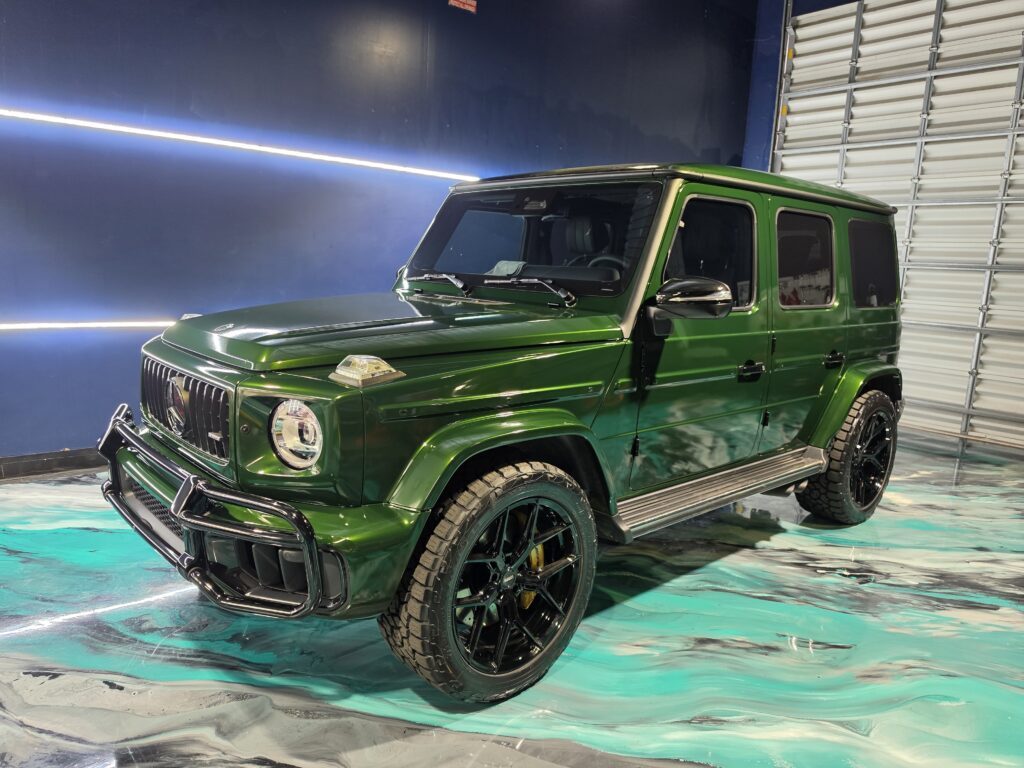 Premium Mercedes-Benz G63 AMG G-Wagon wrapped in gloss British Racing Green vinyl by Wrap Royale in Orlando, FL, featuring luxury vehicle wrap installation, black accents, and professional automotive customization.
